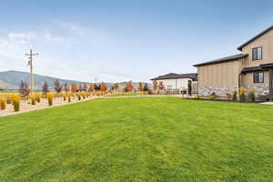 View of grassy yard with a mountain view