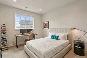 Bedroom featuring light carpet and recessed lighting