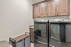 Laundry room with washing machine and dryer and cabinet space