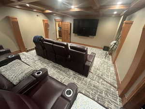 Home theater featuring coffered ceiling, beam ceiling, and recessed lighting