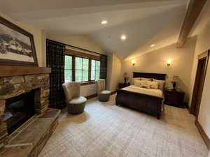 Bedroom with lofted ceiling, a fireplace, light carpet, and recessed lighting