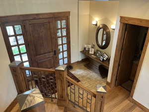Foyer entrance featuring light wood-style floors and stairway