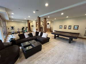 Living area featuring recessed lighting, billiards, stairs, and light colored carpet