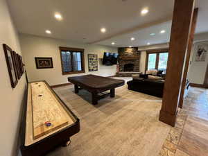 Rec room with recessed lighting, a stone fireplace, and billiards table