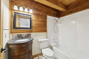 Bathroom with shower / bathtub combination, vanity, beamed ceiling, and tasteful backsplash