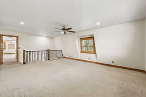Carpeted spare room featuring recessed lighting and a ceiling fan