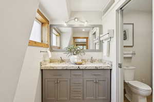 Bathroom featuring double vanity and toilet