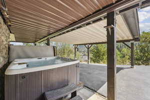 View of patio / terrace with a hot tub