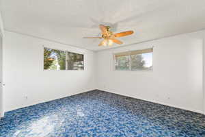 Unfurnished bedroom featuring carpet, a textured ceiling, and a closet