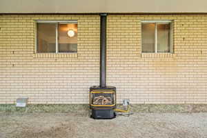 Detailed view of a wood stove and brick siding