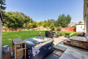 Fenced backyard featuring a patio area and area for grilling
