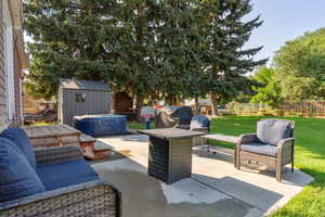 View of patio / terrace with a storage unit and a grill
