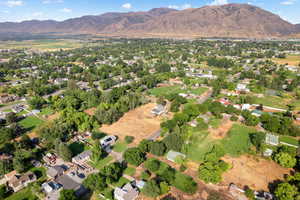 Aerial overview of property's location with a mountain backdrop and nearby suburban area