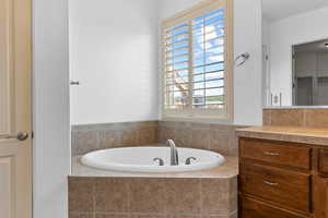 Full bathroom featuring a bath and vanity