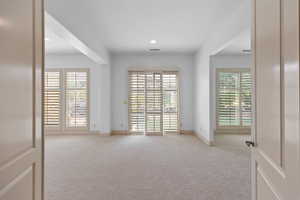 Empty room featuring light colored carpet and recessed lighting