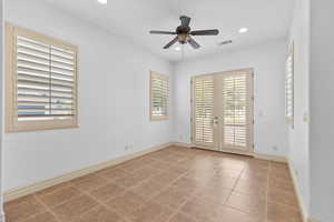 Unfurnished room featuring french doors, light tile patterned flooring, recessed lighting, and a ceiling fan
