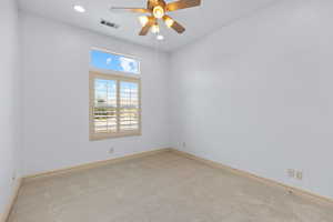 Empty room with carpet floors, a ceiling fan, and recessed lighting