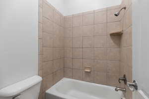 Full bathroom featuring shower / bath combination and toilet