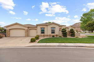 Mediterranean / spanish-style house featuring stucco siding, a garage, concrete driveway, stone siding, and a front lawn