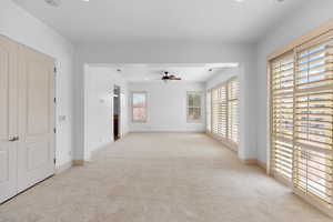 Unfurnished room with light colored carpet, recessed lighting, and a ceiling fan