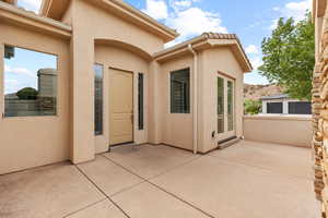 View of exterior entry with stucco siding