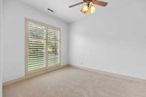 Spare room with carpet floors and ceiling fan