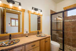 Full bathroom with a stall shower and double vanity