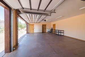 Garage featuring baseboards