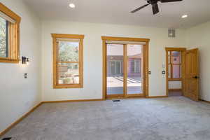 Bedroom with recessed lighting, plenty of natural light, light carpet, and a ceiling fan