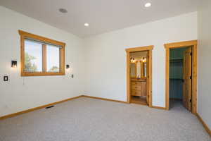 Bedroom featuring carpet flooring, a spacious closet, recessed lighting, and connected bathroom