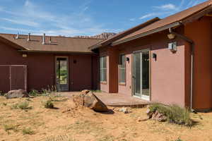 Rear view of house featuring stucco siding and a patio