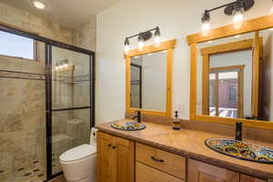 Full bath with a stall shower and double vanity