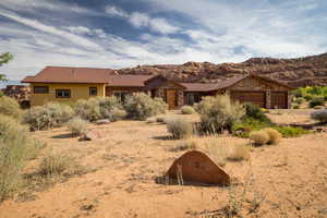Single story home with a metal roof, a garage, and a mountain view