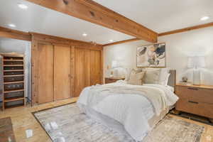 Bedroom with beam ceiling and ornamental molding