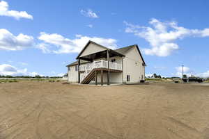Rear view of property with a patio, stairway, and a deck