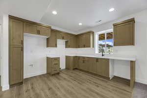 Kitchen with recessed lighting, light wood-type flooring, and brown cabinets