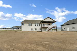 Back of property featuring stairs and a patio area