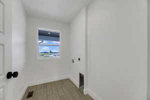 Washroom featuring hookup for an electric dryer and washer hookup