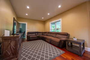 Living room with wood finished floors and recessed lighting