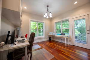 Home office with a chandelier, dark wood-style flooring, and recessed lighting