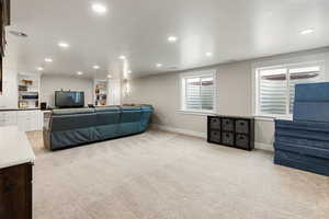 Living room featuring recessed lighting and light carpet
