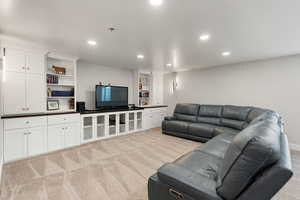 Living area featuring recessed lighting and light carpet