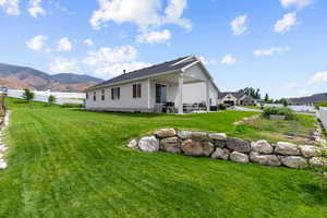 View of property exterior featuring a patio, a mountain view, and crawl space