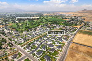 Aerial view of property's location with nearby suburban area and a mountainous background