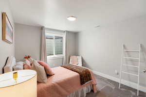 Bedroom featuring baseboards and carpet
