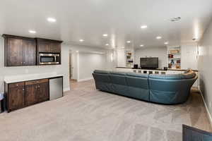 Living area featuring recessed lighting and light colored carpet