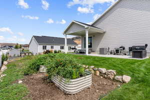 Rear view of property with a patio area and a yard
