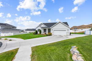 View of front of house featuring board and batten siding, driveway, a garage, and a porch
