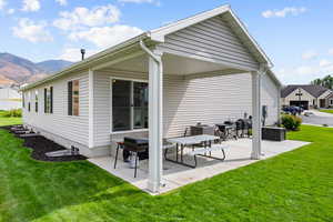 Back of property with a patio and a yard