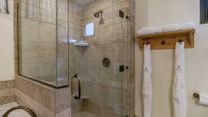 Full bath featuring a shower stall and a bath